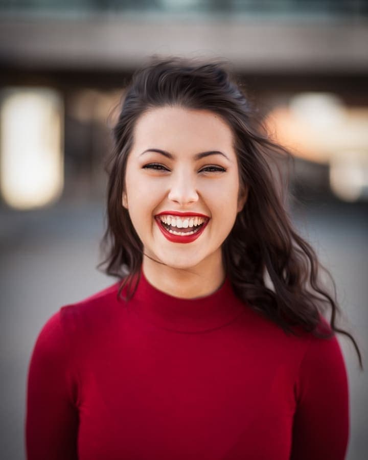 A candidate laughing after reading an interview invitation